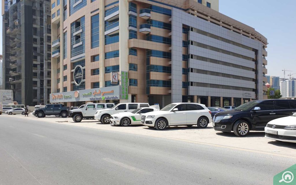 cars parked outside danat al khan tower sharjah
